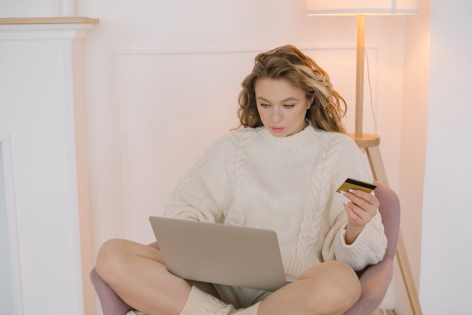 An image of a person shopping online for fashion items on a laptop